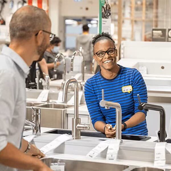 An IKEA co-worker helping customers plan their kitchen in-store