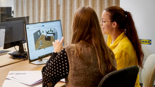 An IKEA co-worker helps a customer design a kitchen in the Kitchen Planner.