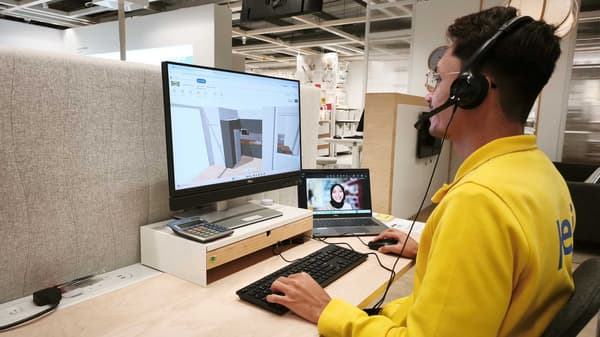 An IKEA co-worker is attending to a customer for an online