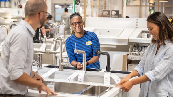 An IKEA coworker talking to two customers