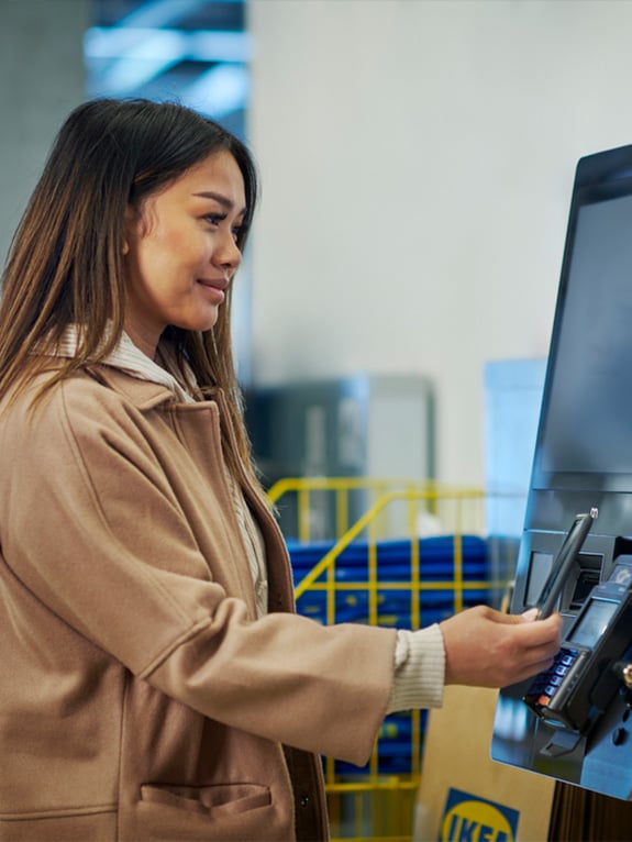 An IKEA Customer paying at the checkout
