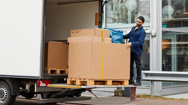 An IKEA delivery man unloading a truck at a mobile pick-up location.