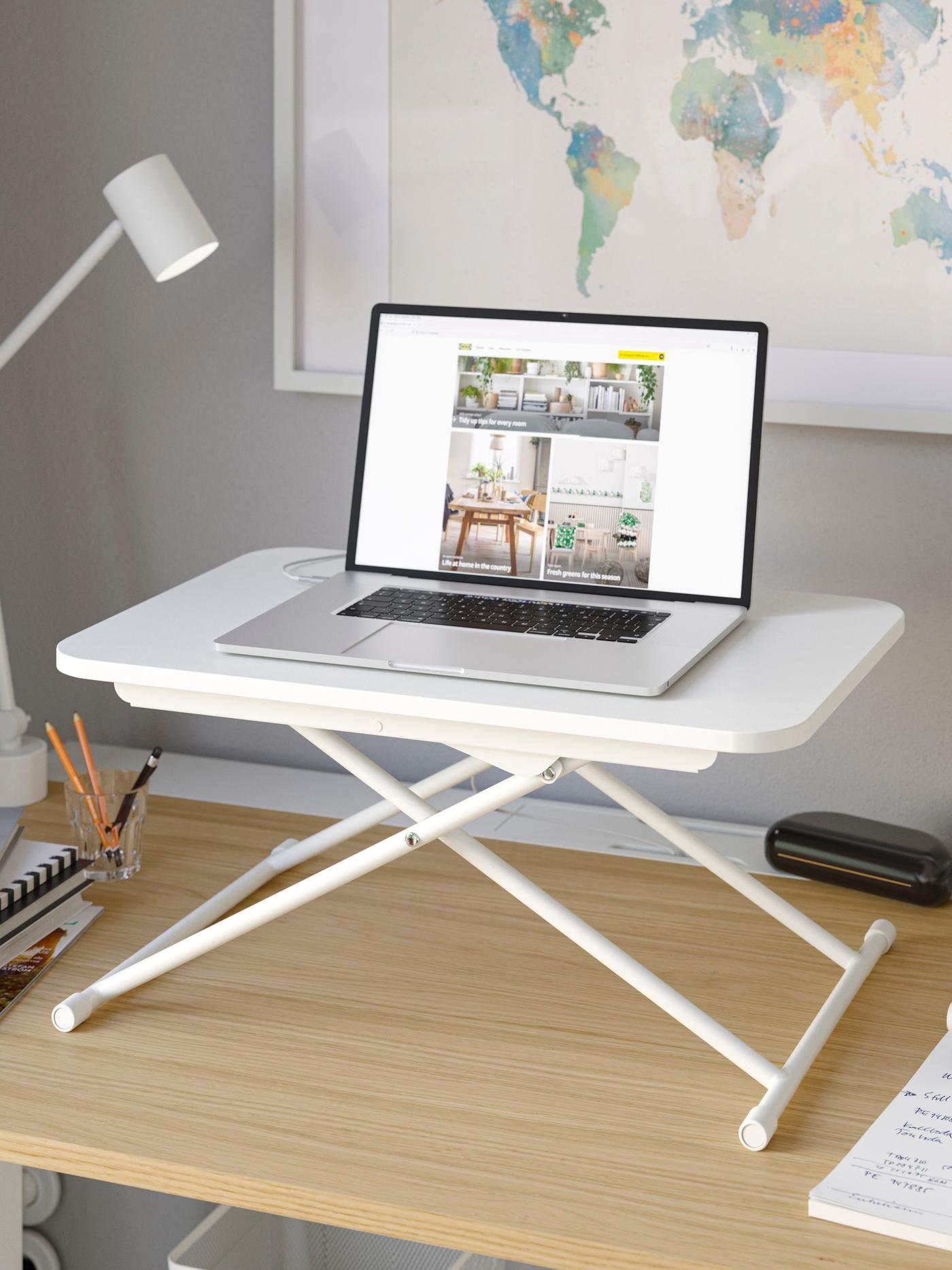 An IKEA DUBBLA laptop stand on top of an oak desk