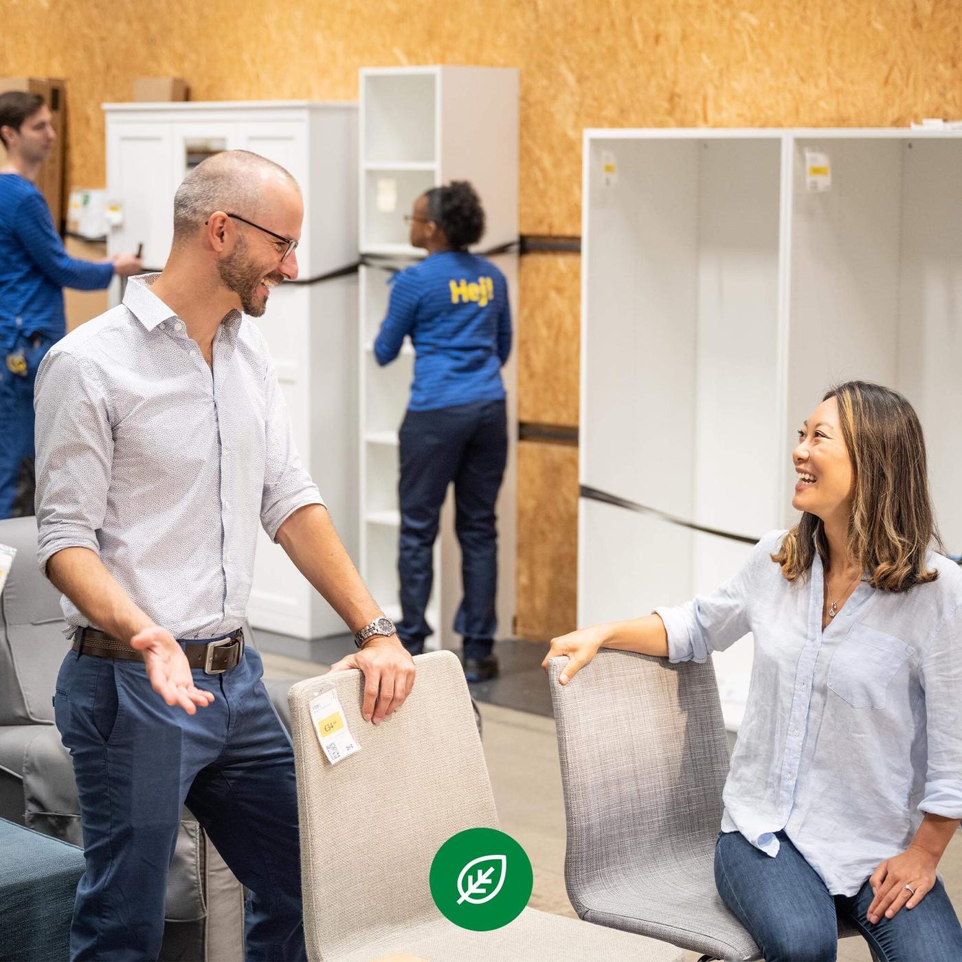 An IKEA employee helping a shopper in the As-is section