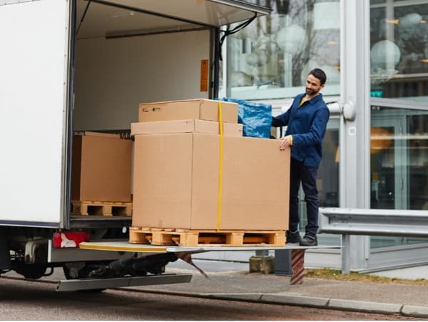 An IKEA employee unloading a package for delivery 