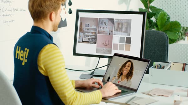 An IKEA for Business employee advises a customer at a desk via video call