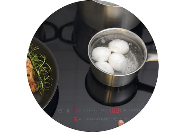 An IKEA induction hob with an IKEA pot of boiling eggs.