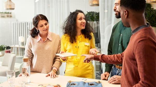 An IKEA interior designer looks at various sample materials with customers.