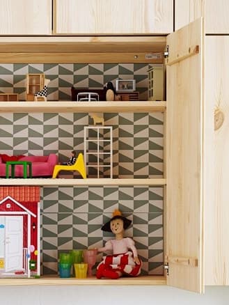 An IKEA IVAR shelving unit doors becoming a doll house with miniature furniture and a puppet.