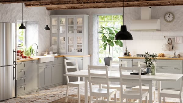 An IKEA LERHYTTAN light grey kitchen with oak worktop and metal handles.