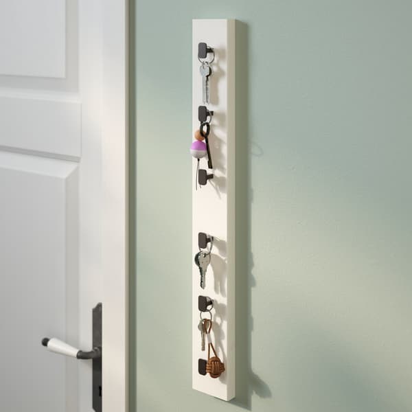 An IKEA LURT rack hanging vertically used to hang house keys.