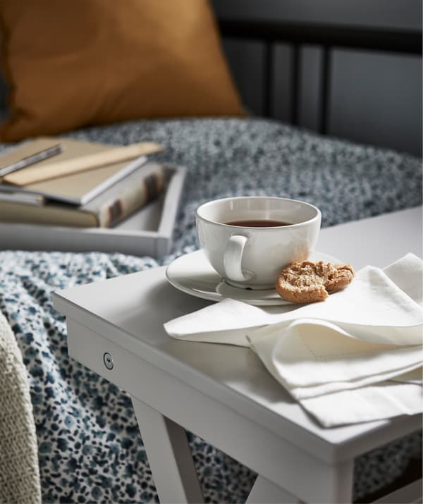 An IKEA MARYD tray table make a perfect spot to keep study snacks and a glass of water.
