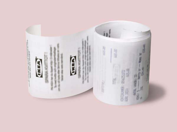 An IKEA paper receipt on a light pink background.