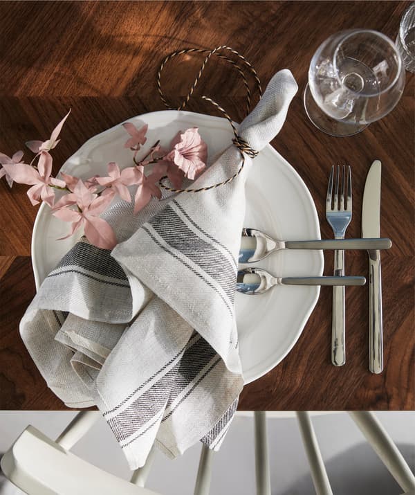 An IKEA VARDAGEN tea towel laying decoratively across a plate.