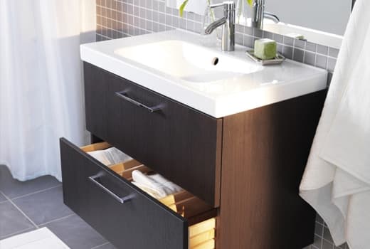 An image of a bathroom sink sitting on a 2 drawer cabinet