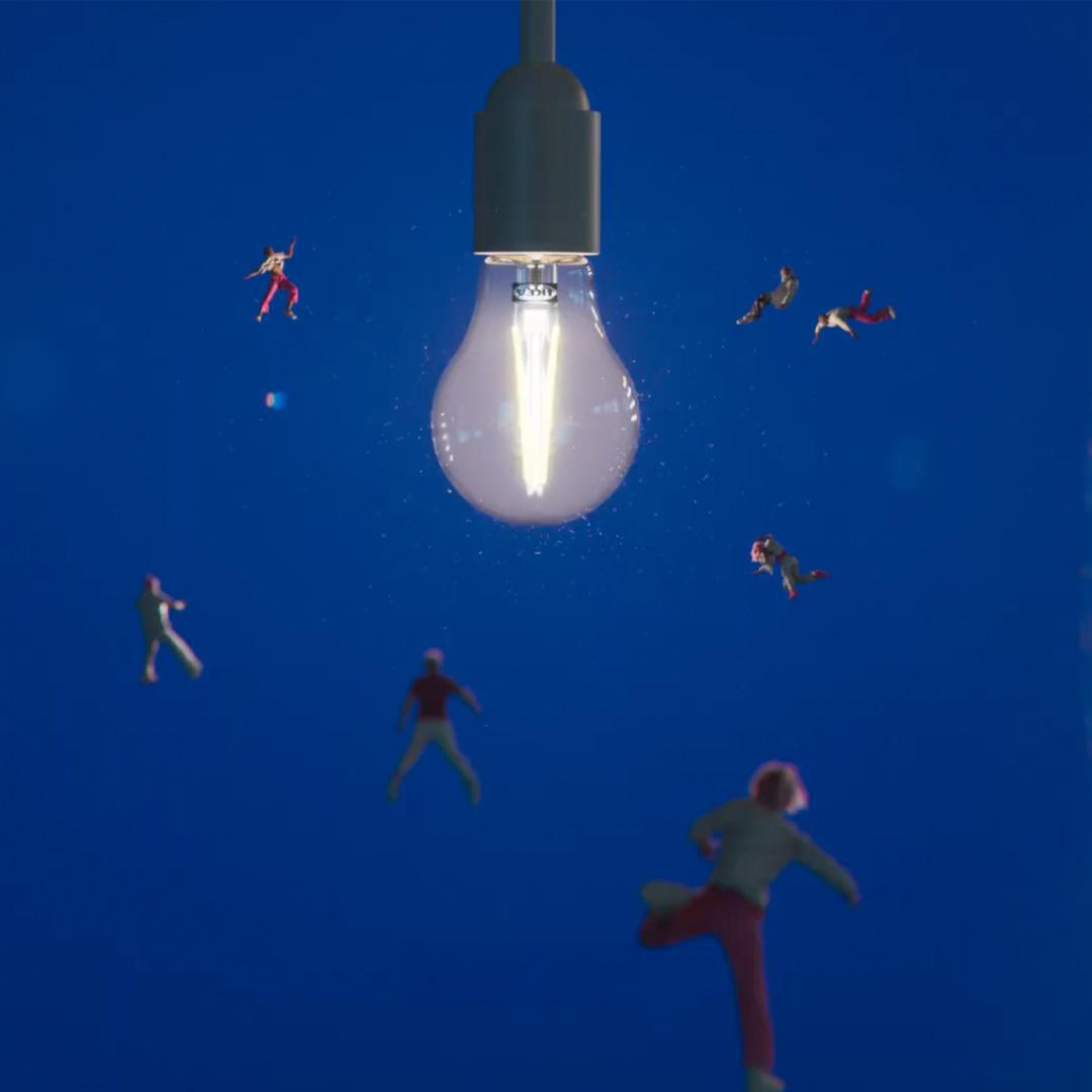 An image of a giant lightbulb surrounded by flying people