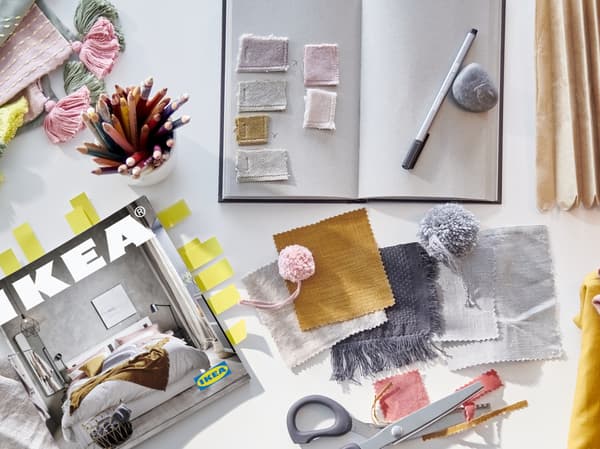 An image of various items including an IKEA magazine, a pair of scissors, and an open notebook.

product collage