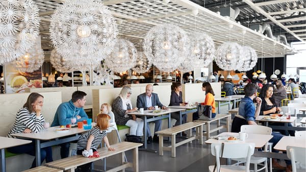 An image showing the seating area of an IKEA restaurant with people seated enjoying their meal.