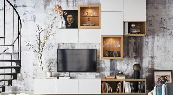 An industrial living room with BESTÅ cabinets on the wall.