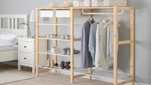 An IVAR wooden storage system with hanging and shelved clothes