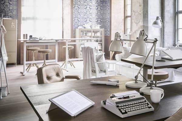 An open office in a loft with bright office furniture in industrial style