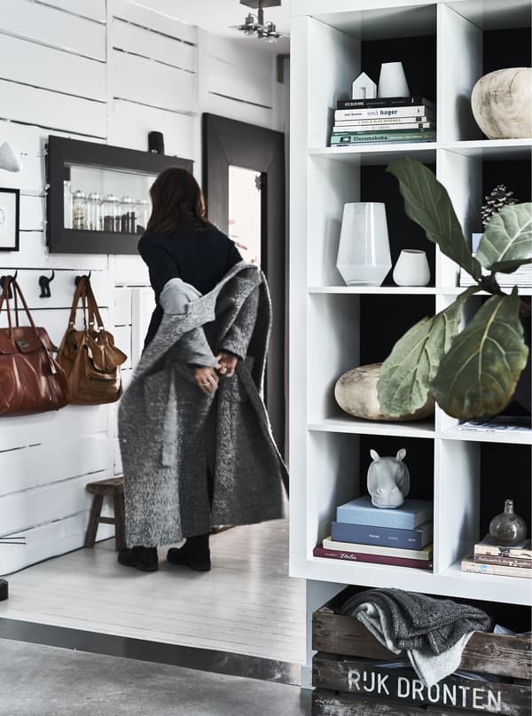 An open storage unit and hallway with white walls.