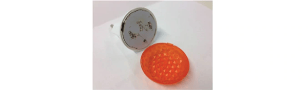 An orange nightlight split open to reveal the inside mechanism.
