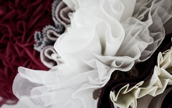 An upside down view of hanging clothes and fabrics.