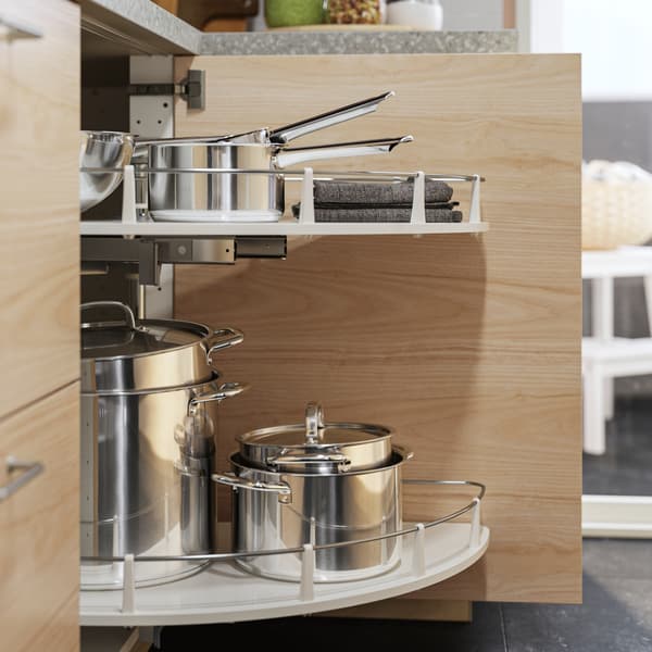 An UTRUSTA corner base cabinet pull-out fitting, in a light ash effect cabinet, has stainless steel IKEA 365+ pots with lids.