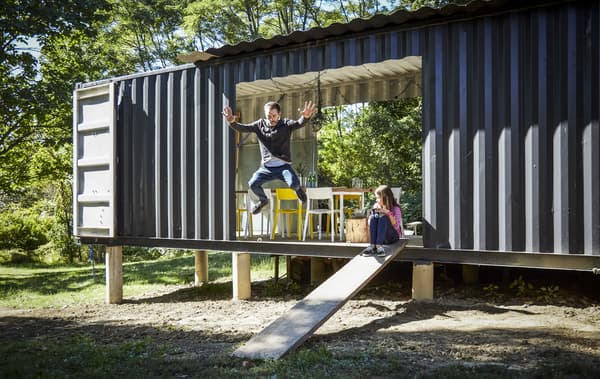 Arno and his daughter at their self-built home.
