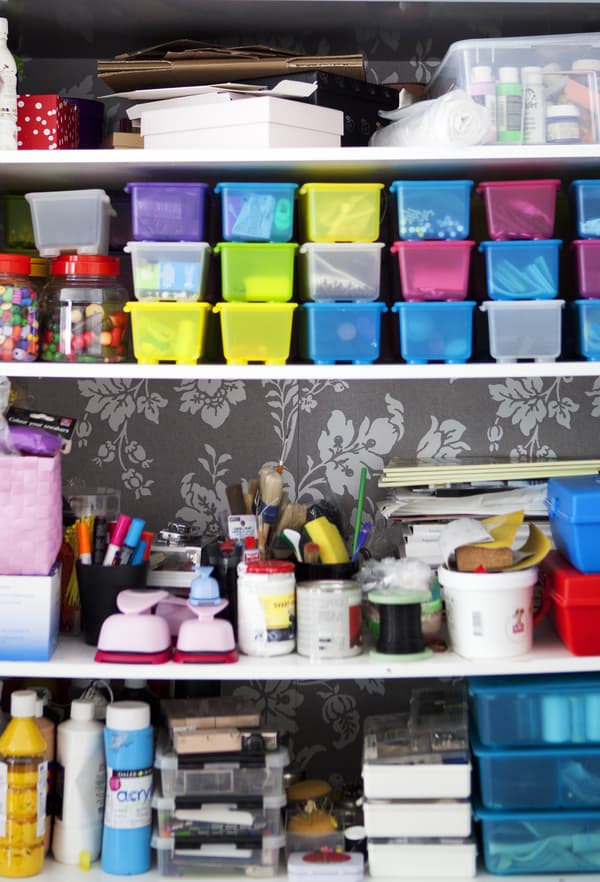 Arts and crafts materials stored in colourful boxes.