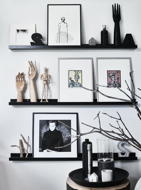 Artwork and objects displayed on picture rails.
