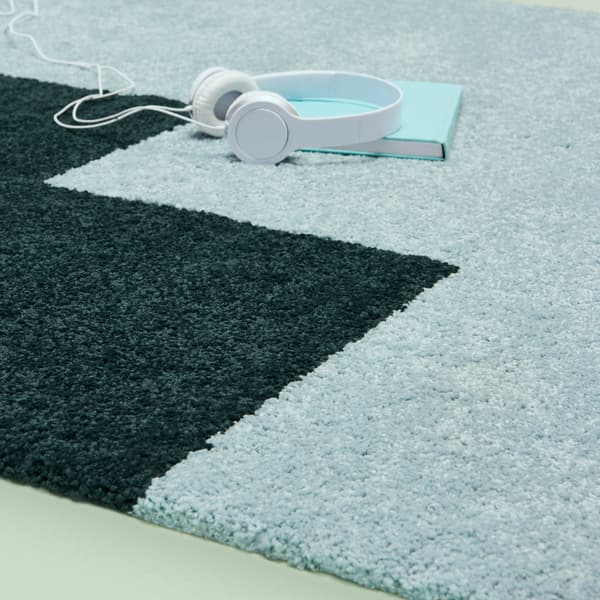 Asymmetrical staircase pattern on a KONGSTRUP rug.