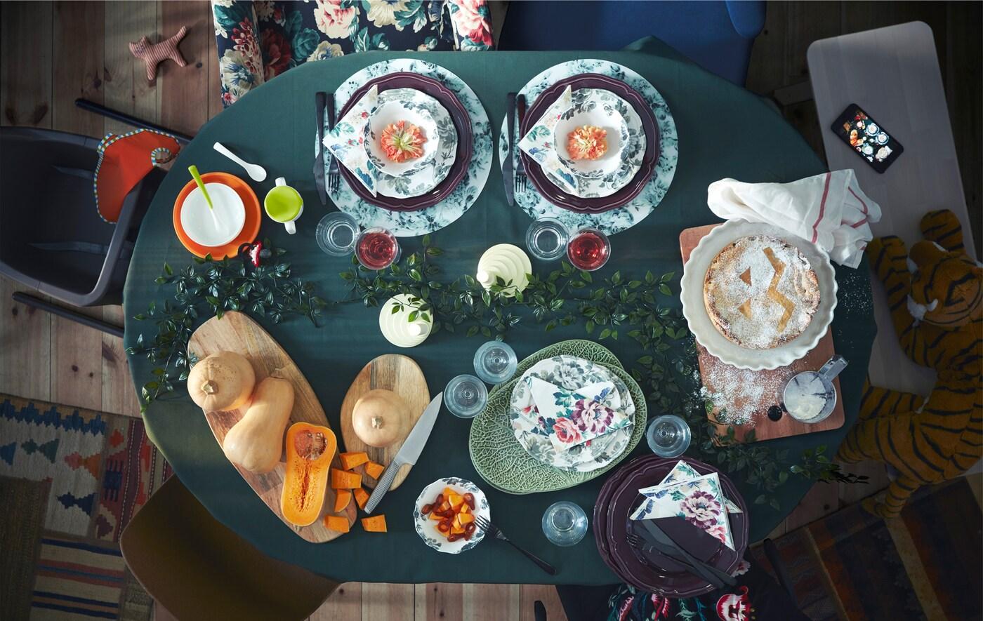 Autumn-styled dining table with decorated plates and fresh pumpkin.