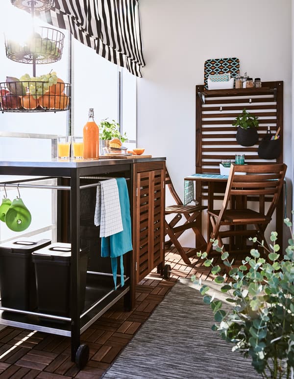 Avec une desserte, une armoire et une petite table, le balcon devient un espace pour cuisiner et manger à l’extérieur.