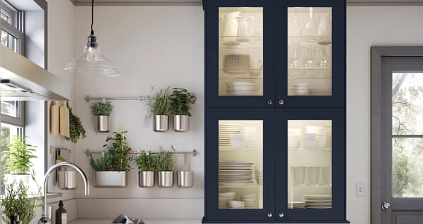 AXSTAD blue kitchen fronts in a kitchen with a white countertop.