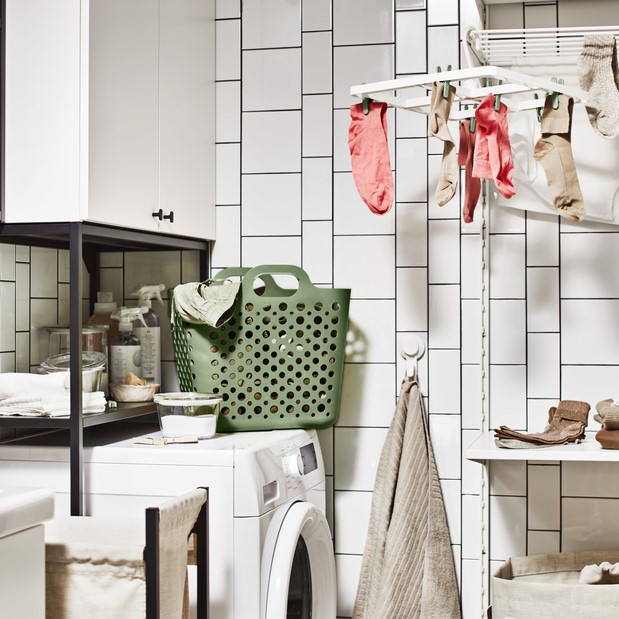 Bahtroom with a washer, laundry basket and other laundry accessories