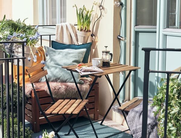 Balkongräcke med krukor med vårblommor. 