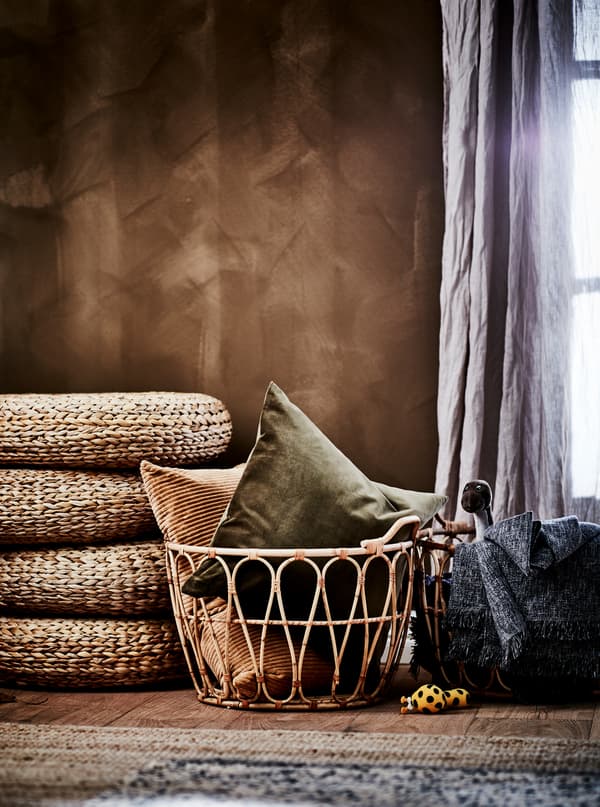 Bedroom section in earthy-brown color scheme: SNIDAD rattan baskets with textiles, ALSEDA stools and natural-material rugs.