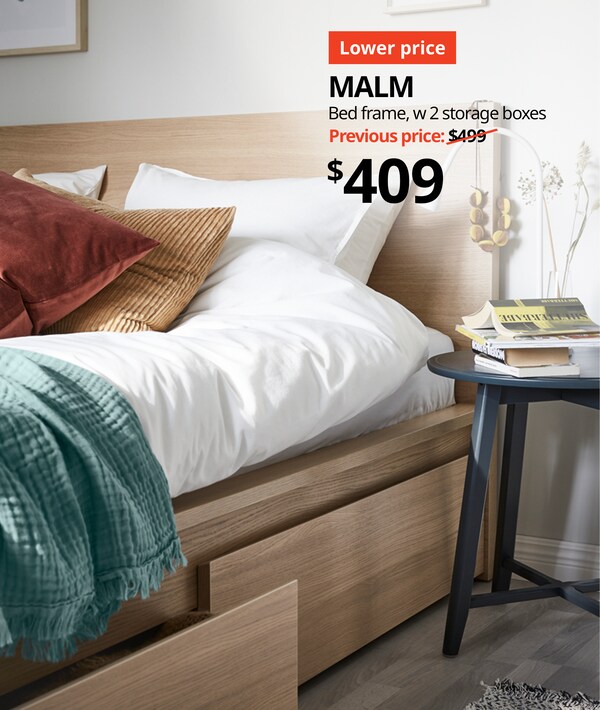 Bedroom with white stained oak MALM bedframe in with white duvet covers and sheets. Text on image reads "Lower price, MALM bedframe w 2 storage boxes, Previous price $499 with slash, $409" 