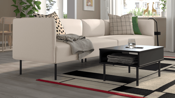Beige LILLEHEM 3-seater sofa in a neutral-toned living room, featuring a black coffee table and decorative cushions.