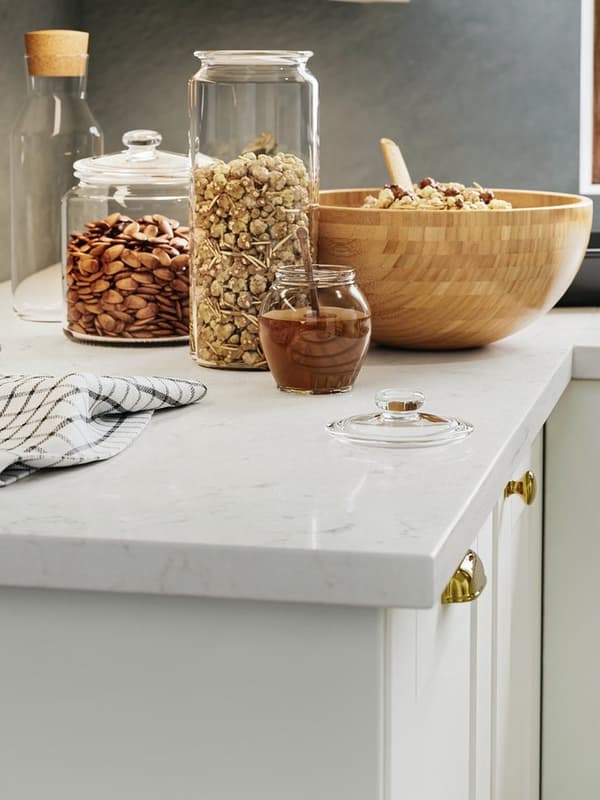 Benchtop with a bowl and glass jars on top 