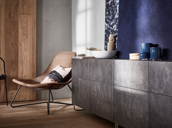 BESTÅ storage units with doors in a dark grey concrete faded effect with curved metal feet.