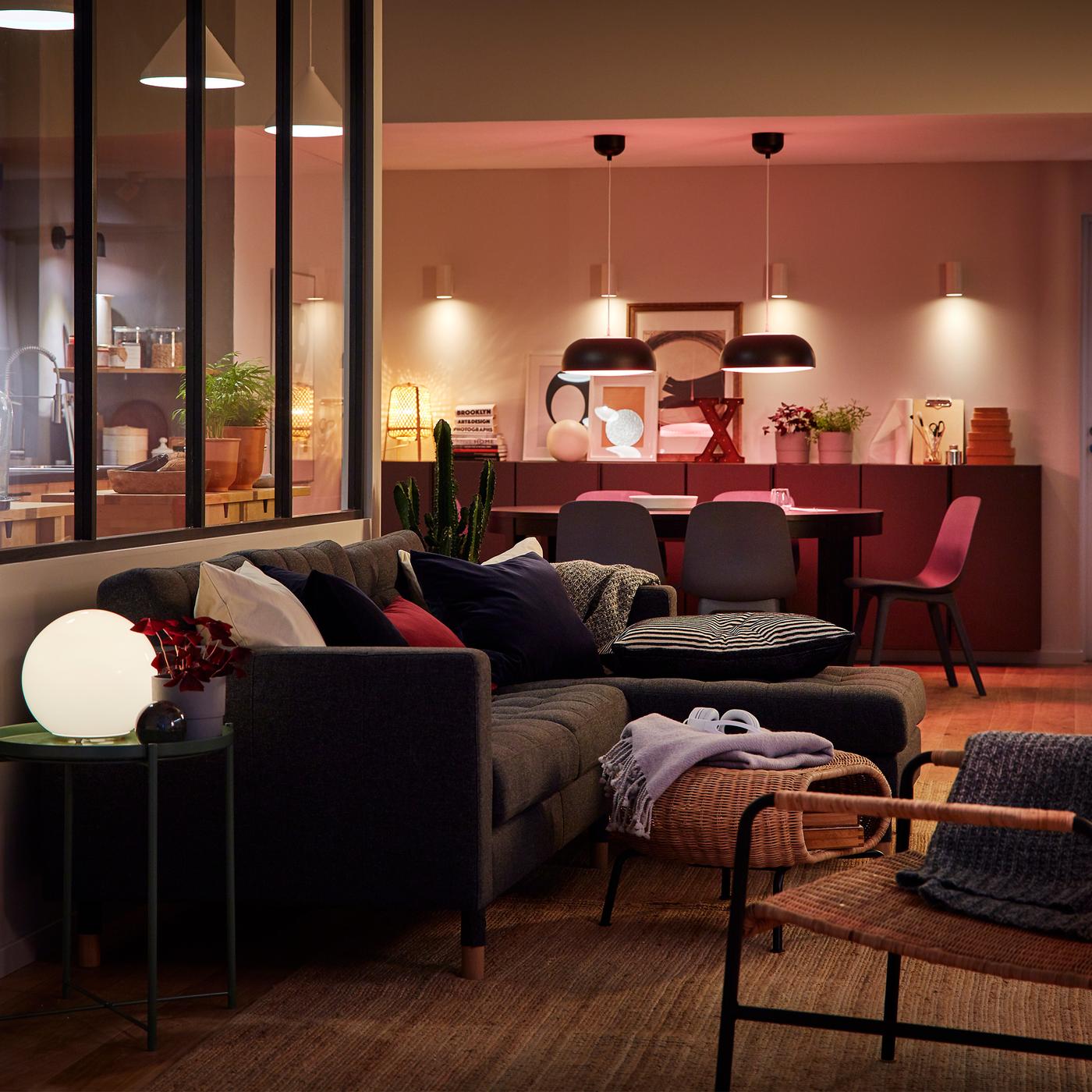 Big room with kitchen, dining area and living room only marginally separated. Room lit with multiple light sources.