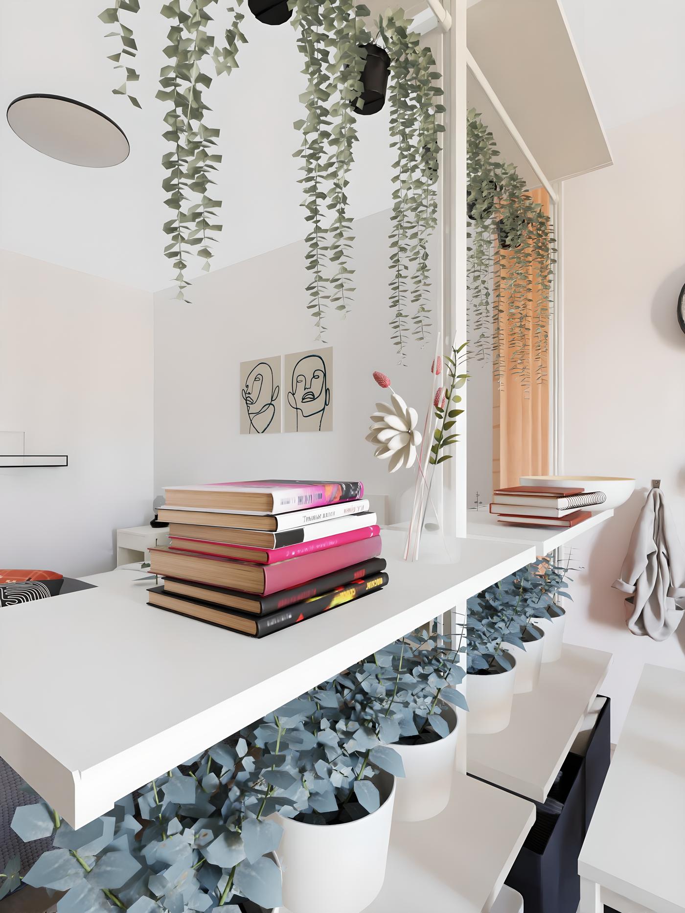 Bijeli stol s knjigama, viseće biljke i cvijeće u vazi. U pozadini su dvije slike i stolica.