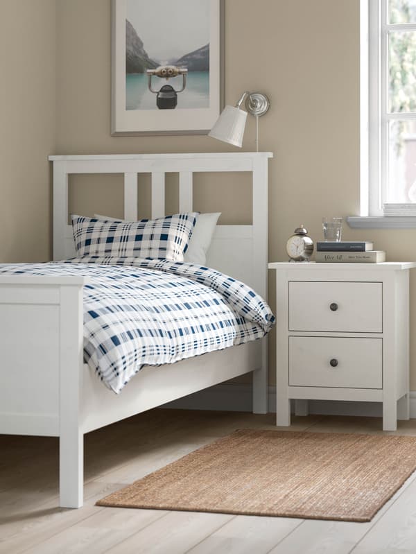 Bílá postel HEMNES a noční stolek HEMNES.