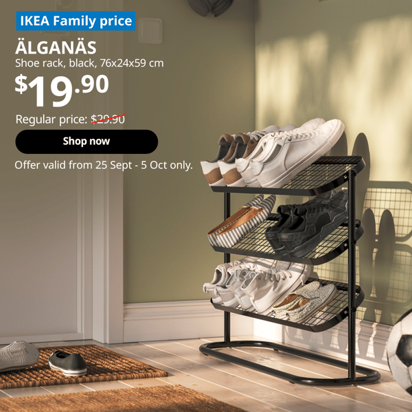 Black ALGANAS shoe rack near the main entrance of the home, with pairs of shoes neatly placed on top. Text on image reads "IKEA Family price, ALGANAS, Shoerack, black, 76x24x59 cm, $19.90, Regular price: $29.90 with a slash, Shop now, Offer valid from 25 Sept - 5 Oct only."