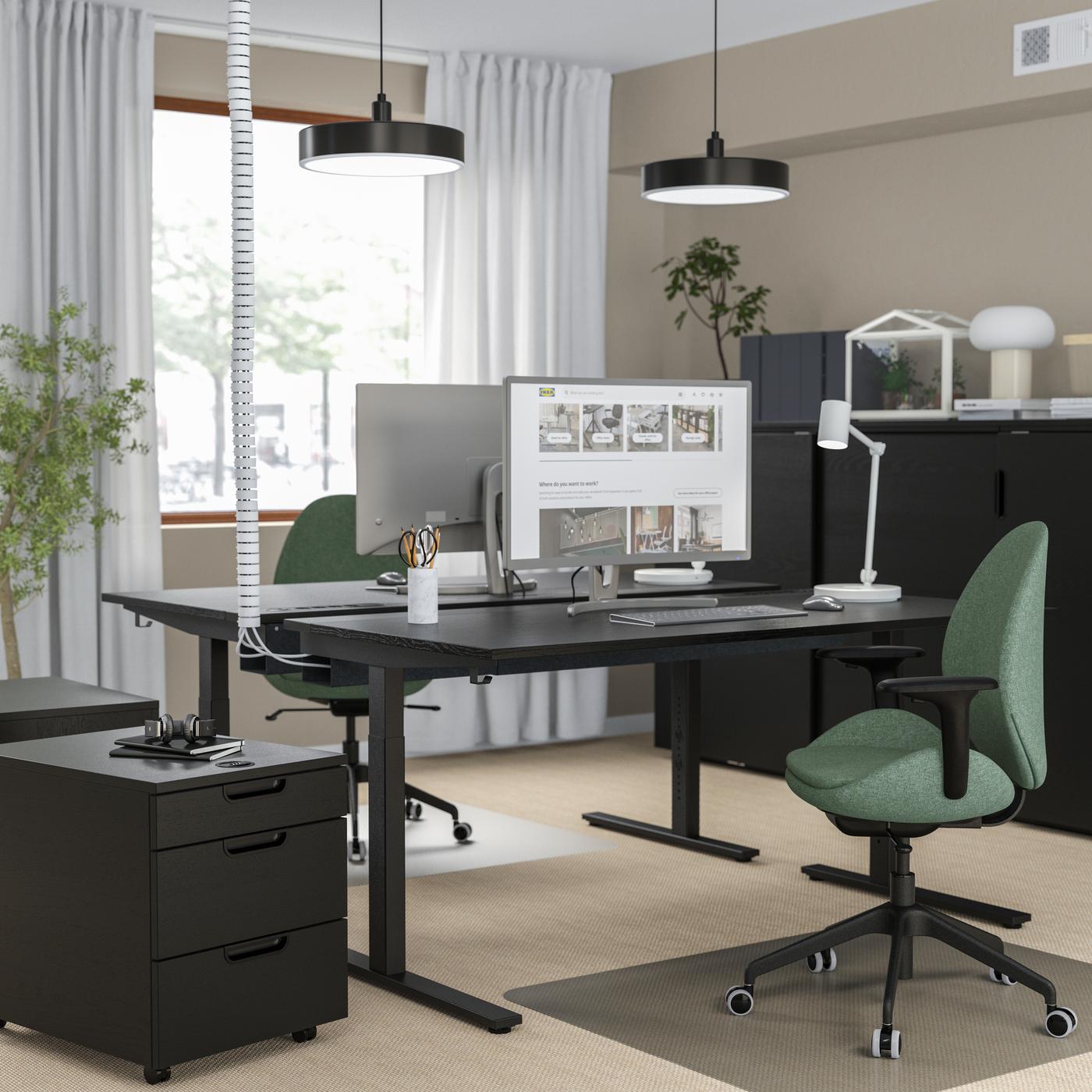 Black MITTZON desks with green chair