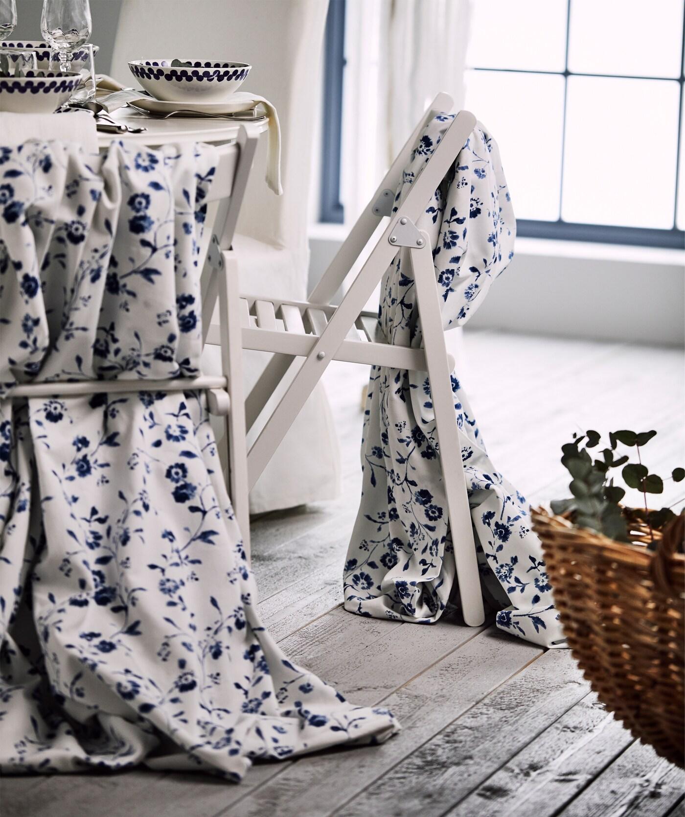 Blue and white fabric draped over TERJE chairs for a traditional wedding