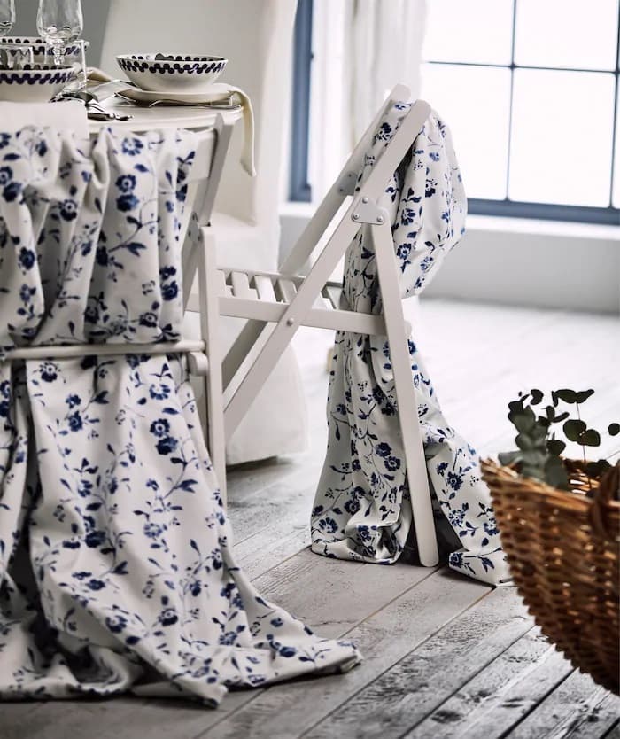 Blue and white fabric draped over TERJE chairs for a traditional wedding